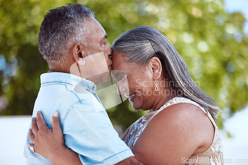 Image of Elderly, couple and happy with love, hug and kiss on face in backyard, garden or park together in summer. Man, woman and retirement show romance, bonding and care in nature, smile and embrace