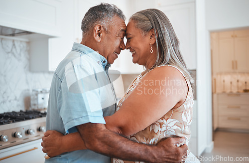 Image of Hug, love and senior couple with smile for retirement, marriage or support in the kitchen of their house. Happy and elderly man and woman hugging on their anniversary in their home together