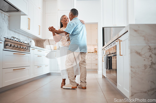 Image of Couple, elderly and dance in kitchen for love, romance and happy together while home in retirement. Senior, man and woman do fun dancing in house for bonding, happiness and care with smile on face