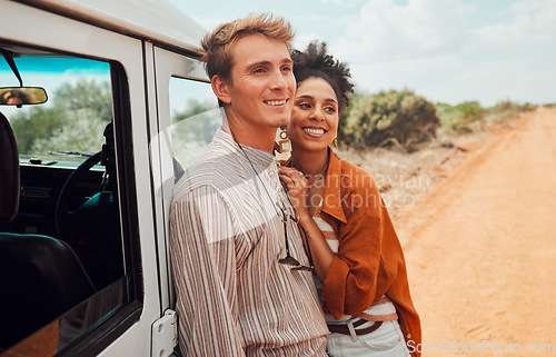 Image of Happy couple, travel and smile for road trip in the countryside on vacation together in nature. Interracial man and woman smile for relationship traveling, adventure and holiday bonding in the desert