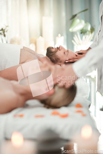 Image of Man, spa and bed for luxury massage to relax, breathe and zen on vacation, holiday or hotel with woman. Couple, mindfulness and love for health at wellness, care and physical therapy for healing