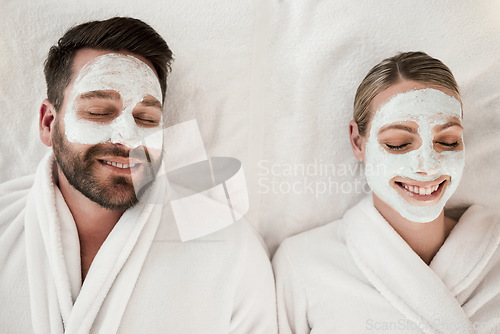 Image of Skincare, spa and face mask with relax couple smile, happy and luxury cosmetic treatment together from above. Man and woman skincare, beauty and wellness at a health clinic for relaxation body care