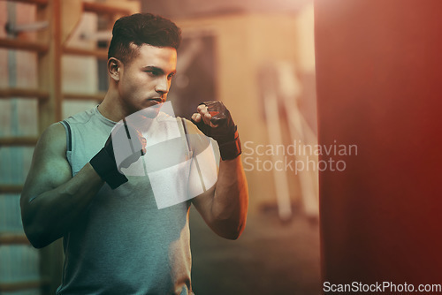 Image of Boxer, workout or training man with punching bag working on sports fitness, exercise and strength. Athlete, fighter or martial arts in a boxing, health and wellness gym or fight club studio