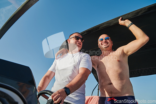 Image of Friends on luxurious yacht on the open sea, relaxing in the warmth of the sun, as they enjoy a day filled with adventure and friendship.