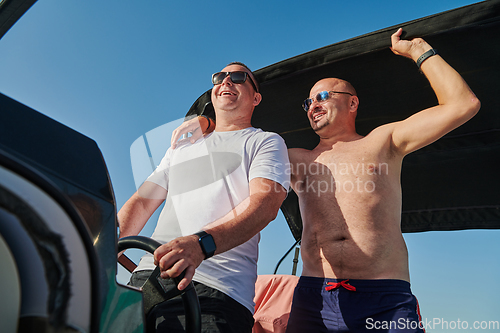 Image of Friends on luxurious yacht on the open sea, relaxing in the warmth of the sun, as they enjoy a day filled with adventure and friendship.