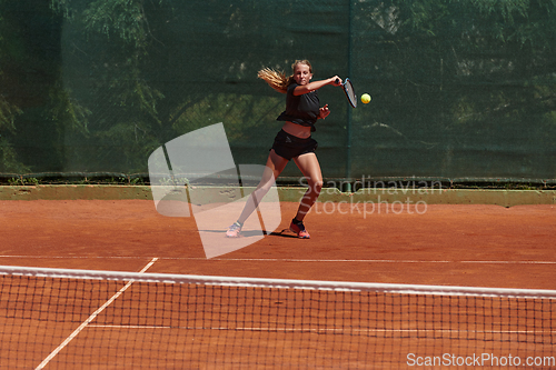 Image of A young girl showing professional tennis skills in a competitive match on a sunny day, surrounded by the modern aesthetics of a tennis court.