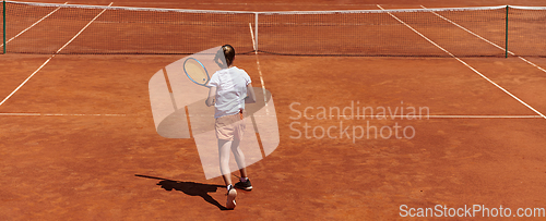 Image of A young girl showing professional tennis skills in a competitive match on a sunny day, surrounded by the modern aesthetics of a tennis court.