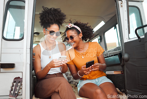 Image of Women, road trip or phone for social media, gps location or map app for safari game drive or summer travel. Smile, happy or bonding friends with 5g mobile technology in camper van in nature landscape