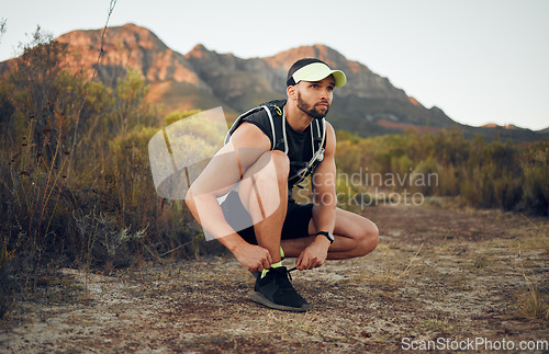 Image of Exercise, fitness on mountains and runner man with outdoor workout, wellness and healthy lifestyle with motivation or goal. Young person training on hiking dirt road in the morning with sports shoes