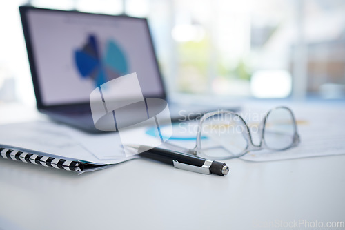 Image of Office, empty and desk with laptop graph for business analytics in corporate company side. Professional workspace table with online ui data screen for enterprise management and development.