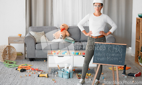 Image of Cleaning, living room and blackboard with a woman mother in her home to clean up children toys off of the floor. Mom, cleaner and mess with a strict female in messy lounge with a helmet and goggles