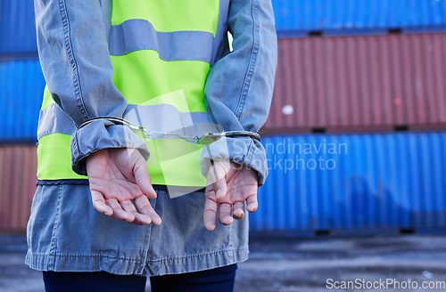 Image of Hands, man and arrest of engineer in handcuffs for theft, crime or fraud. Corruption, law and logistics, shipping or container worker or criminal in hand cuffs arrested for bribery, scam or stealing.