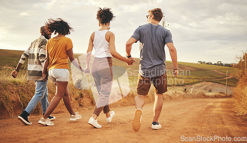 Image of Support, holding hands and friends on a vacation in the countryside walking on a dirt road. Nature, freedom and happy group of people in the desert on a summer holiday, journey or adventure.