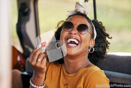 Image of Happy, road trip and black woman eating a strawberry in a car on a travel holiday in nature. Portrait of a young, funny and African girl with fruit in a van on vacation for adventure and freedom
