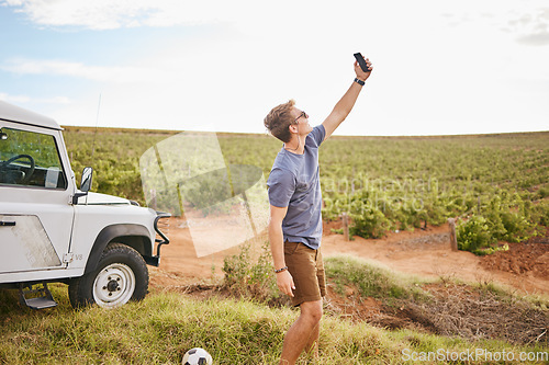 Image of Phone selfie, travel and car road trip nature of a man using a mobile outdoor on a drive break. Countryside, summer vacation and person using technology near a agriculture farm and motor transport