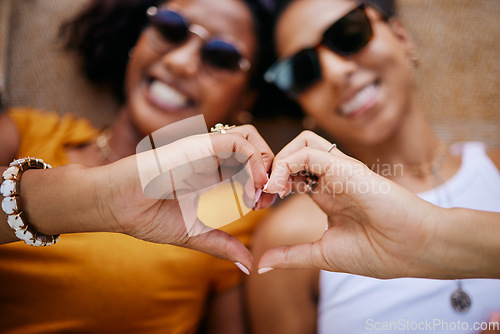 Image of Heart sign, lgbtq couple and women happy, smile and show relationship together being romantic. Love, queer, or friends or proud black girls celebrate loving, romance or peace while relax with passion