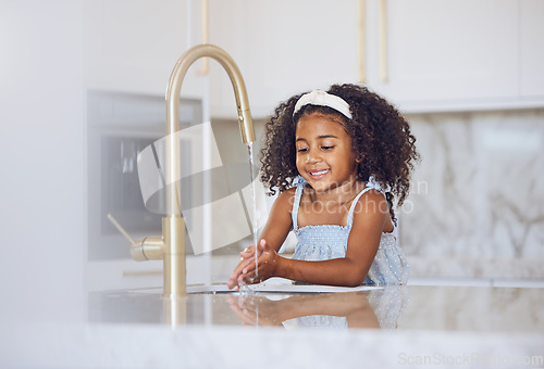 Image of Little girl, washing and hands with smile in the kitchen for healthy clean hygiene at home. Happy black female child rinsing and cleaning hand by the sink at the house after a day outside