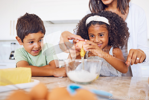 Image of Cooking, food and children with a girl and boy baking or learning in the kitchen of their home together with mom. Kids, egg and bake with a mother teaching a brother and sister how to make cake mix