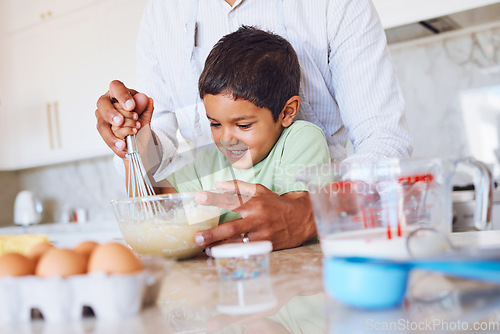 Image of Baking, kid and father in kitchen learning to make cake, cookies or biscuits in home. Support, care and bonding with parent teaching boy how to cook, bake and cooking with eggs, wheat flour and milk