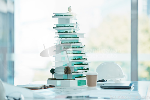 Image of Architecture, model and mockup design of a 3d miniature future building on a table in office. Engineering, planning and mini apartment construction structure for architectural or industrial project.