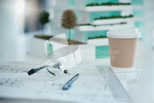 Image of Architecture, planning and design on desk with drawing tools, safety glasses and coffee. Blueprint, vision and idea for architect, engineer or construction worker in building or construction industry