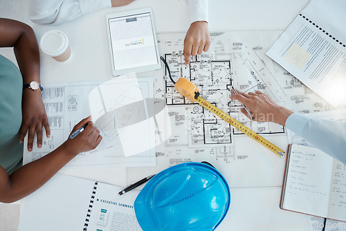 Image of Top view, hands and engineering meeting for the blueprint of a floor plan for a construction building group project. Productivity, architecture and global team working, drawing and planning a design