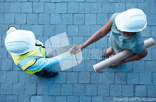 Image of Architect partnership, client handshake and construction worker meeting at building site, property deal or engineering trust. Above industrial contractor shaking hands, agreement or design consulting