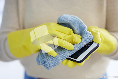 Image of Hands, gloves and cleaning phone screen of germs, bacteria with alcohol wipe or dust cloth. Covid, disinfection and safety, clean smartphone in home or office for protection from virus infection.