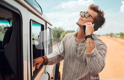 Image of Phone, road trip and vehicle breakdown with a man on a call for roadside assistance while on holiday or vacation in the desert. Transport, stranded and alone with a young male calling for help