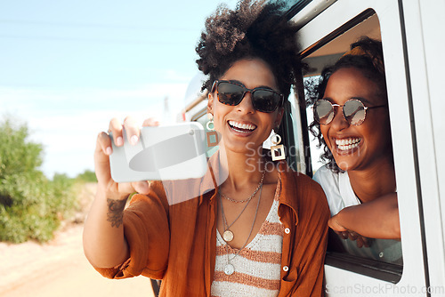 Image of Selfie, smile and friends on a road trip with a car during a safari holiday in Kenya. African women with phone for photo, communication and social media live streaming on vacation in the desert