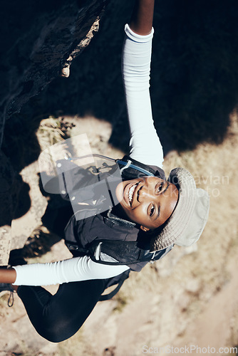 Image of Hiking, black woman or rock climbing on mountain for workout or fitness. Girl, health and exercise for training, sport or wellness on adventure in nature in summer on hill, hiker or stone in Canada