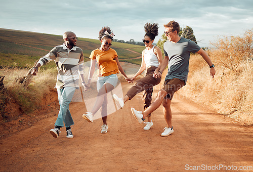 Image of Travel, friends holding hands and dance in nature, outdoors or countryside on vacation. Happy, diversity and group smile, spending time together and dancing, celebration and having fun on sandy road.