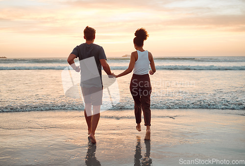 Image of Sunset, beach and couple walking holding hands in ocean for outdoor holiday, date or summer vacation with horizon, sky mock up. Love, care and support people running, bonding by the sea for wellness