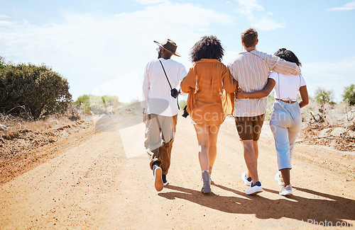 Image of Friends, walking and travel with young people in nature on a sand road with a beautiful desert view of the sky. Vacation, summer and walk with a man and woman group outdoor for a trip or holiday