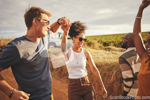 Image of Friends, road trip and dance with a man and woman on a vacation, holiday or getaway in the dessert on a sand road. Travel, diversity and nature with a group of young people enjoying freedom outside