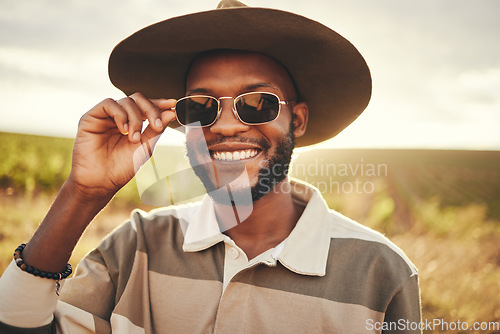 Image of Black man, sunglasses and farm fashion, holiday vacation and travel with fresh look, cool and relax on road trip. Young male, wear hat and happy smile, adventure and getaway during summer break.