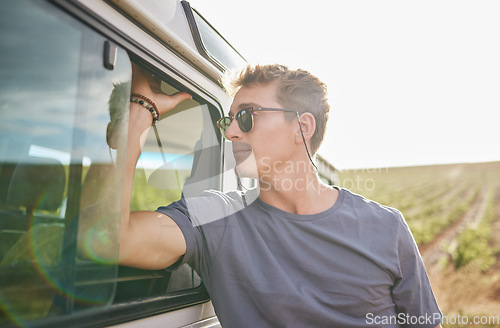 Image of Travel, adventure and man by his car in the countryside while on a roadtrip during summer vacation. Sunshine, outdoors and young person in nature, relax on journey and traveling lifestyle.