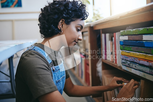 Image of Books, creative and Indian student search bookshelf for reading poetry information, learning or knowledge in a work studio or classroom. Teenager woman with history, philosophy or dictionary research