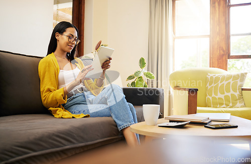 Image of Woman, networking or communication with tablet on sofa for social media app, search or contact us on website. Technology, female with glasses in house for email, internet or ecommerce shopping