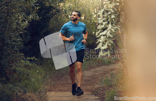 Image of Running, fitness man and forest run on a trail for exercise, workout and training in nature for health and wellness. Athlete man out jogging or active in the woods with trees and fresh air for cardio