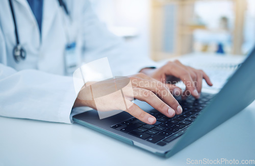 Image of Hands, laptop and healthcare with a doctor typing for research, doing a search on the internet in a hospital. Computer, medical and analytics with a male medicine professional at work in a clinic