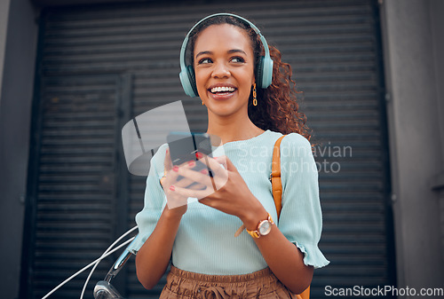 Image of Black woman, smile and phone for social media in the city with headphones in joy for 5G connection in the outdoors. Happy African female student smiling for technology or internet on smartphone