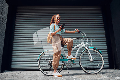 Image of Bicycle, woman and phone in city feeling excited and happy about message while outdoor in summer with trendy look. Eco friendly transportation for carbon footprint female on a bike using 5g network