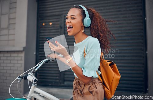 Image of Woman, happy and bicycle with music on phone while on ride in city. Black woman, excited and smile with smartphone for communication, call or streaming on app with bike to reduce carbon footprint