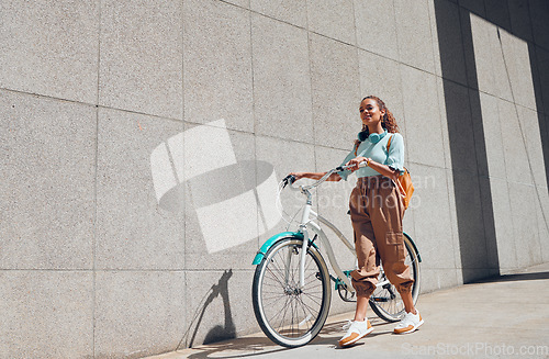 Image of Bike, urban and city woman on a bicycle ride walking to cut carbon footprint for sustainability. Person relax after riding on a summer day feeling calm and relax with eco friendly transportation