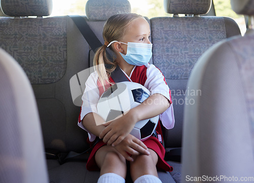 Image of Covid, soccer and girl in a car to travel in backseat to a youth football training game for exercise and training. Face mask, coronavirus and young child in traffic traveling to a kids sports match