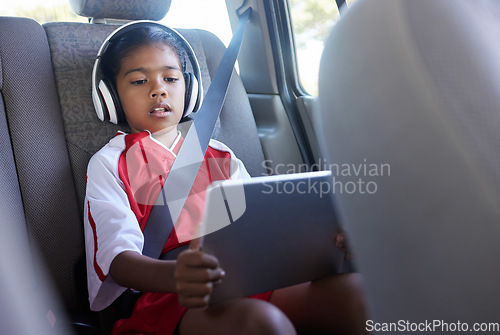 Image of Sports, car travel and relax child with tablet on journey to soccer practice while streaming video, watch movie or play online games. Transport, SUV van or kid girl using tech before football match