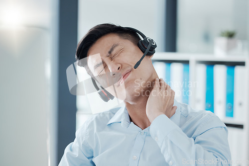 Image of Man, call center and pain in neck from stress, burnout and tired in customer support, communication and telemarketing. Asian, muscle and hand after hurt from work in crm, support and help in Tokyo