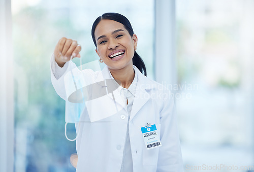 Image of Doctor, covid end and smile of a woman healthcare employee in a hospital or clinic holding a mask. Portrait of a medical professional and consultant from Guatemala happy to after corona safety