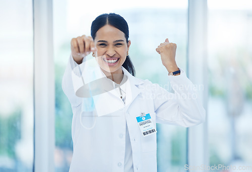 Image of Doctor, happy and celebration with mask off face for end of covid 19, pandemic and coronavirus. Woman, medic and smile in hospital, clinic or healthcare cheering for stop of virus, bacteria or germs